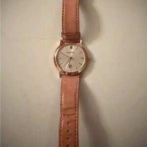 Bulova Watch w/ champagne toned face, rose gold hands, & light tan leather strap